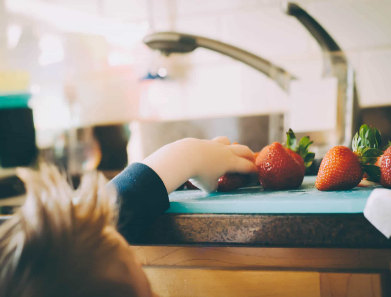 boy-reaching-for-strawberries