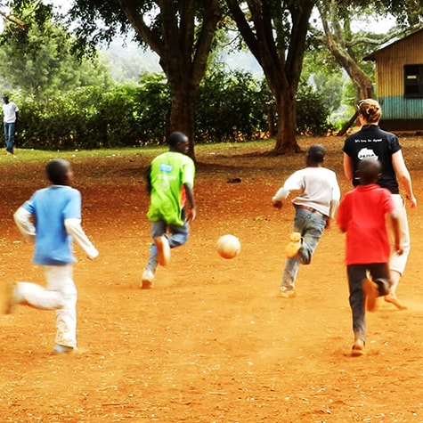 Kids in Playing Football With Volunteer in Kenya